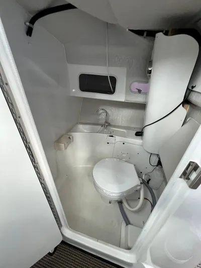  Yacht Photos Pics Compact bathroom in NJM NSB-28 boat, featuring toilet and shower, 2023 model.