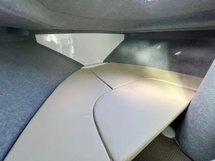  Yacht Photos Pics 2023 NJM NSB-28 interior cabin with cushioned seating and gray upholstery.