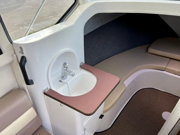  Yacht Photos Pics Compact interior of 2023 NJM NSB-28 boat with sink and seating area.