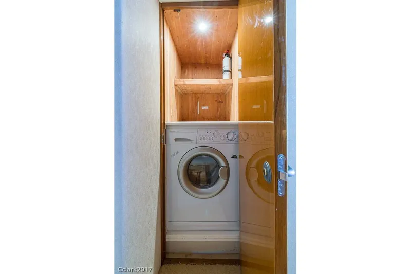 No Pressure Yacht Photos Pics Compact laundry area with a washing machine in a wooden cabinet, 2007 Post 53 Convertible.