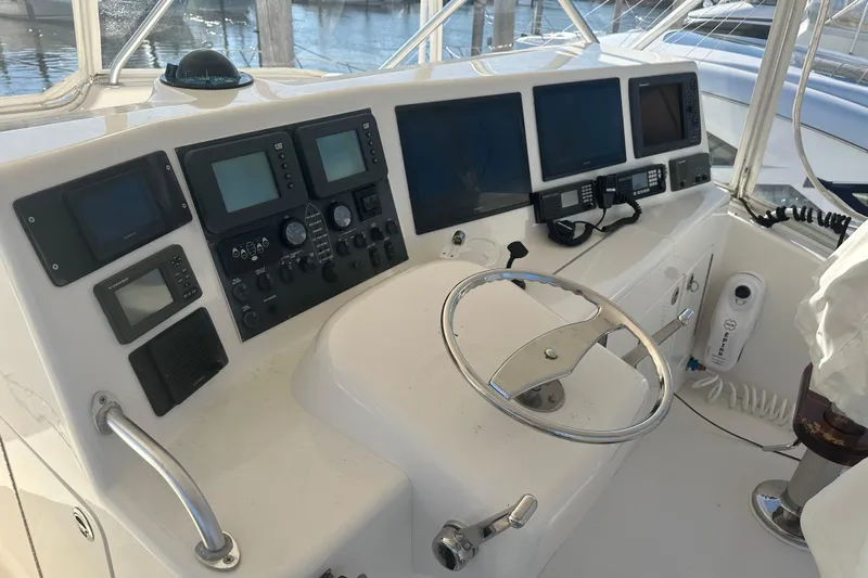 No Pressure Yacht Photos Pics Control panel of a 2007 Post 53 Convertible yacht with multiple navigation screens.