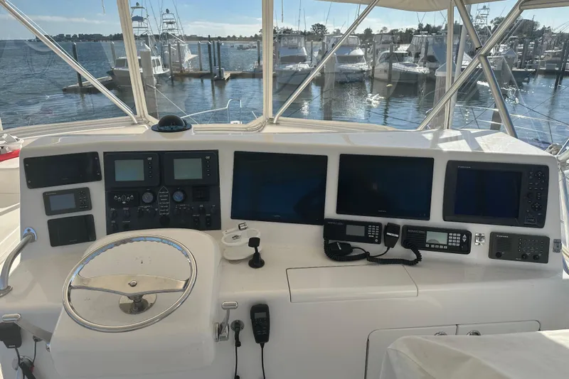 No Pressure Yacht Photos Pics Control panel of a 2007 Post 53 Convertible yacht with navigation screens and steering wheel.