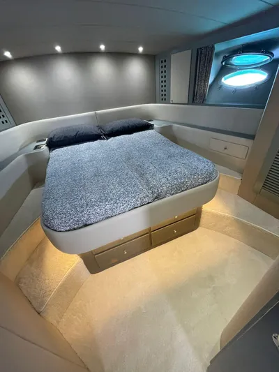  Yacht Photos Pics Luxurious cabin interior of a 1989 Riva 51 Turborosso yacht with modern bedding.