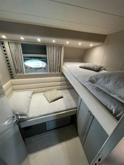  Yacht Photos Pics Interior of 1989 Riva 51 Turborosso yacht with cozy bunk beds and porthole window.