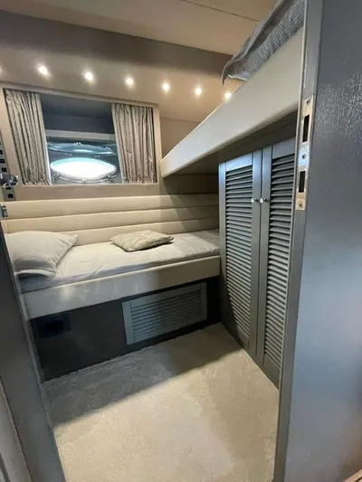  Yacht Photos Pics Interior of 1989 Riva 51 Turborosso yacht with cozy bed and storage.