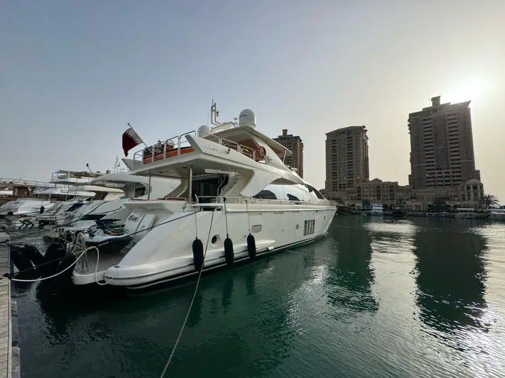 G-one Yacht Photos Pics Luxury 2009 Azimut 82 yacht docked in marina with city skyline backdrop.