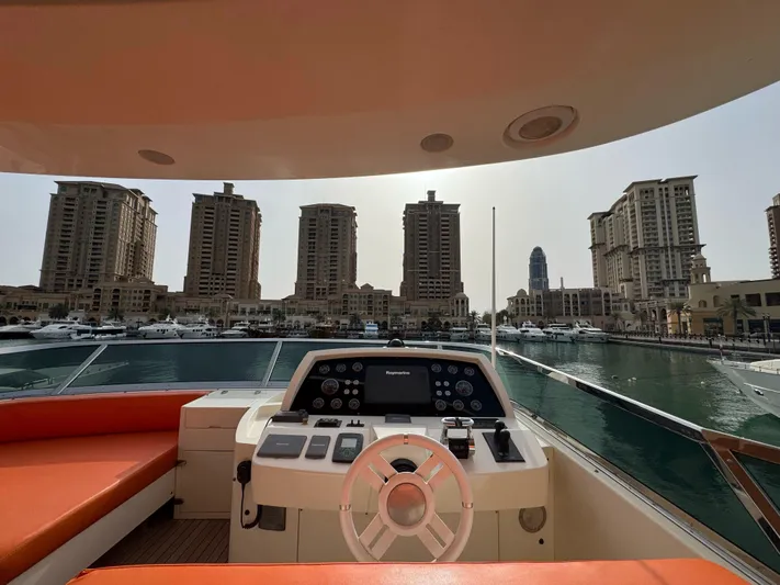 G-one Yacht Photos Pics Helm of 2009 Azimut 82 yacht overlooking marina with tall buildings.