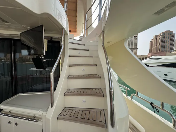 G-one Yacht Photos Pics Staircase on a 2009 Azimut 82 yacht with modern design and waterfront view.