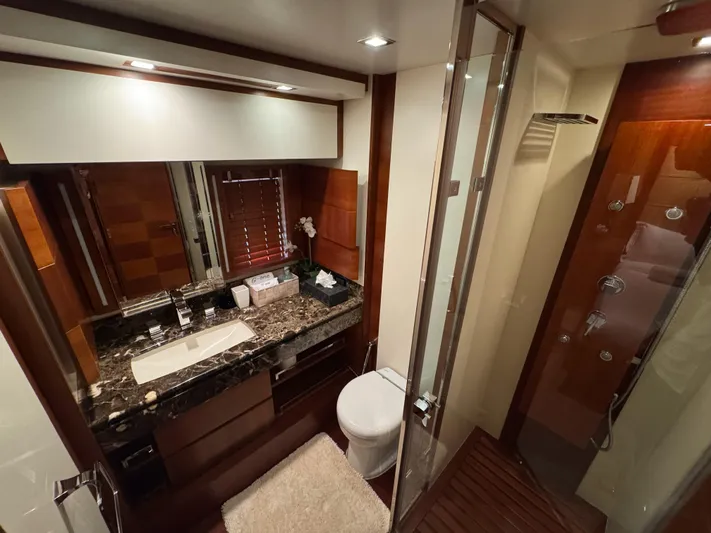 G-one Yacht Photos Pics Luxurious bathroom on 2009 Azimut 82 yacht with marble countertop and glass shower.