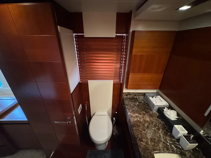 G-one Yacht Photos Pics Luxurious bathroom in 2009 Azimut 82 yacht with wooden accents and marble countertop.