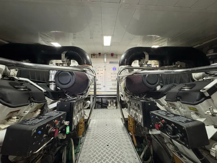 G-one Yacht Photos Pics Engine room of a 2009 Azimut 82 yacht, featuring dual engines and control panels.