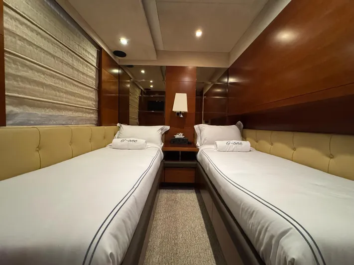 G-one Yacht Photos Pics Luxurious twin cabin interior of a 2009 Azimut 82 yacht with elegant wood paneling.