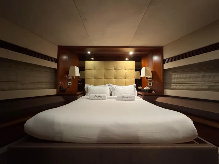 G-one Yacht Photos Pics Luxurious bedroom interior of 2009 Azimut 82 yacht with elegant bedding and ambient lighting.