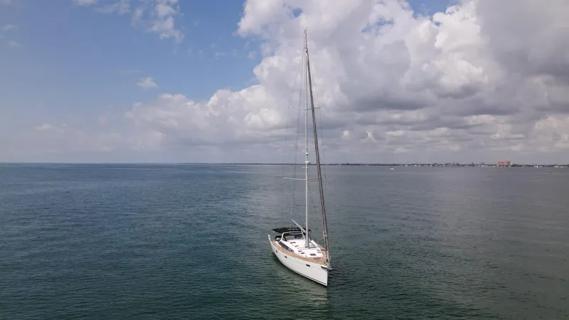 Indigo Dream Yacht Photos Pics Sailing yacht Beneteau Sense 50 (2012) on calm sea under cloudy sky.