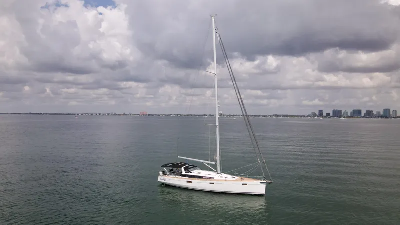 Indigo Dream Yacht Photos Pics Sailing yacht Beneteau Sense 50 (2012) on calm waters under cloudy skies.