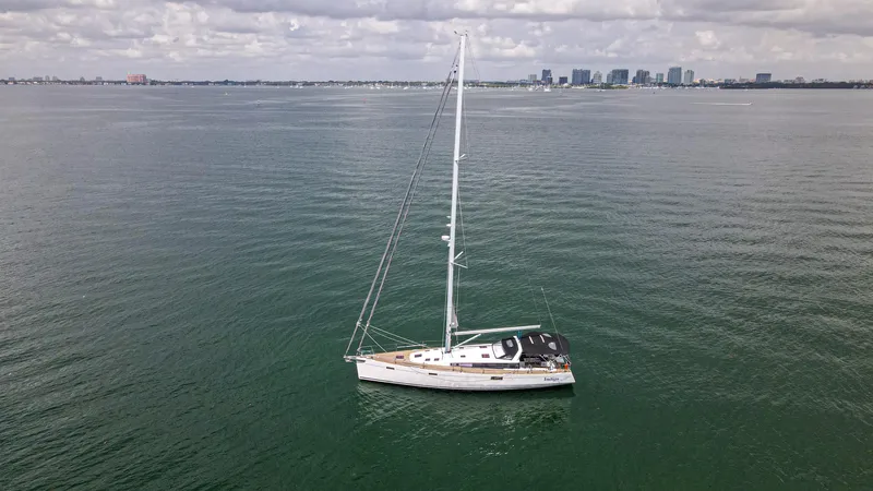 Indigo Dream Yacht Photos Pics Sailing yacht Beneteau Sense 50, 2012 model, on calm waters with city skyline background.