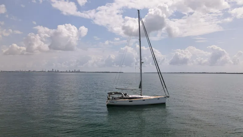 Indigo Dream Yacht Photos Pics Sailing yacht Beneteau Sense 50 (2012) on calm sea under cloudy sky.