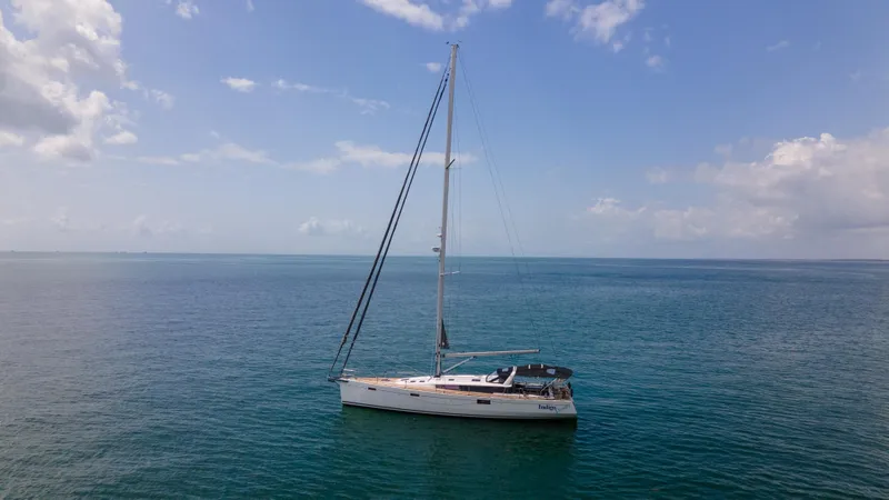 Indigo Dream Yacht Photos Pics Sailing yacht Beneteau Sense 50, 2012 model, on calm ocean waters under a clear sky.