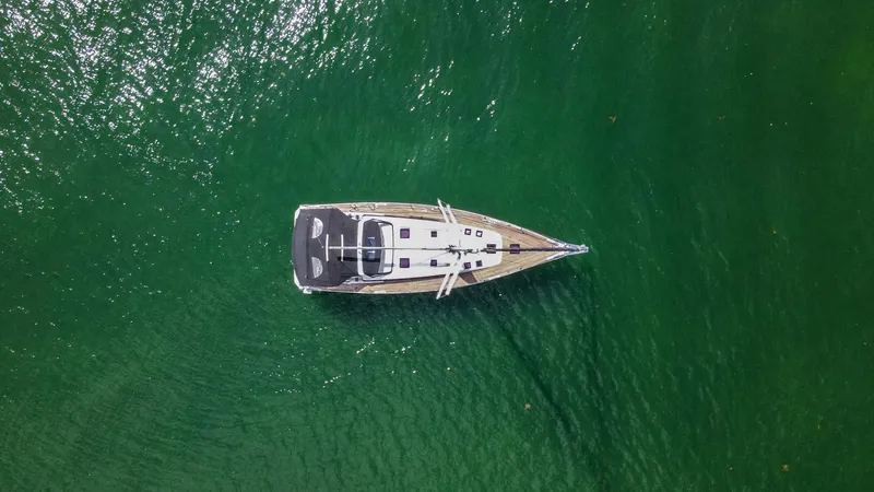 Indigo Dream Yacht Photos Pics Aerial view of 2012 Beneteau Sense 50 yacht on green water.