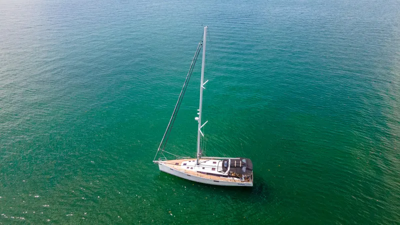 Indigo Dream Yacht Photos Pics Aerial view of 2012 Beneteau Sense 50 sailboat on calm green water.