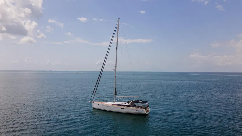 Indigo Dream Yacht Photos Pics Sailing yacht Beneteau Sense 50 (2012) on calm ocean under clear sky.