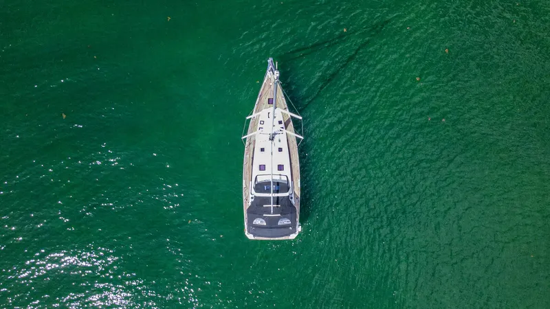 Indigo Dream Yacht Photos Pics Aerial view of 2012 Beneteau Sense 50 yacht on vibrant green water.