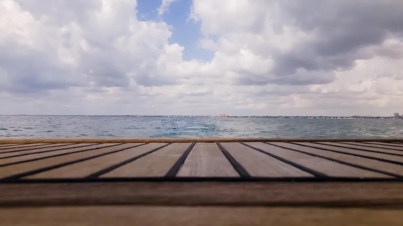 Indigo Dream Yacht Photos Pics View from Beneteau Sense 50 yacht deck, overlooking calm sea and cloudy sky, 2012 model.
