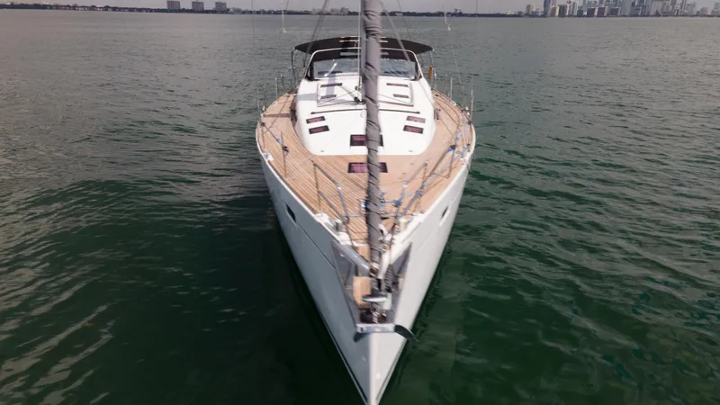 Indigo Dream Yacht Photos Pics 2012 Beneteau Sense 50 yacht on calm water with city skyline in background.