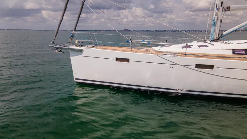 Indigo Dream Yacht Photos Pics Sailing yacht Beneteau Sense 50, 2012 model, cruising on calm waters under cloudy skies.