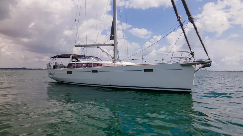 Indigo Dream Yacht Photos Pics 2012 Beneteau Sense 50 sailboat on calm water under cloudy sky.