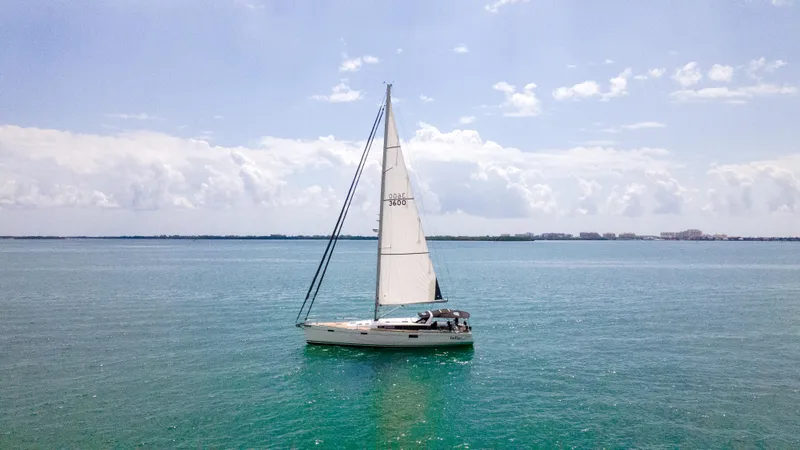 Indigo Dream Yacht Photos Pics Sailing yacht Beneteau Sense 50, 2012 model, cruising on calm blue waters under a clear sky.