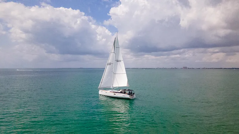 Indigo Dream Yacht Photos Pics Sailing yacht Beneteau Sense 50 (2012) on open sea under cloudy sky.