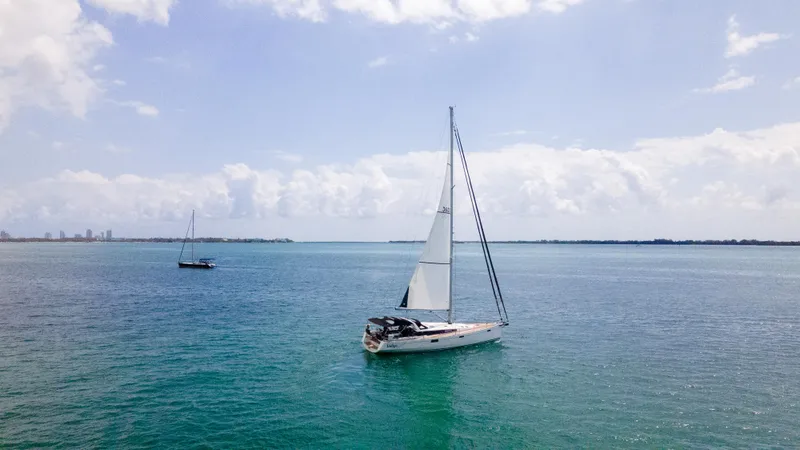 Indigo Dream Yacht Photos Pics Sailing yacht Beneteau Sense 50 (2012) on calm blue waters under a clear sky.
