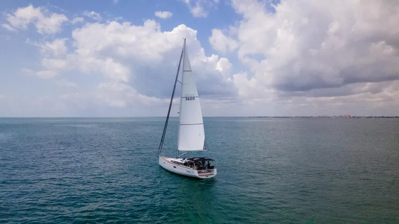 Indigo Dream Yacht Photos Pics Sailing yacht Beneteau Sense 50 (2012) on open sea under cloudy sky.