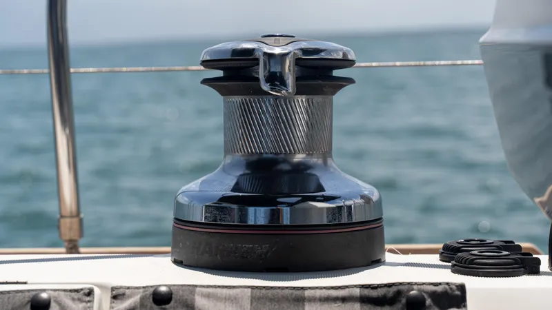 Indigo Dream Yacht Photos Pics Winch on 2012 Beneteau Sense 50 yacht deck with ocean background.