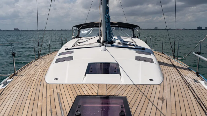 Indigo Dream Yacht Photos Pics Beneteau Sense 50 sailboat deck, 2012 model, cruising on open water under cloudy skies.