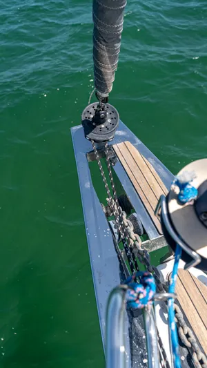 Indigo Dream Yacht Photos Pics Bow of 2012 Beneteau Sense 50 sailboat with rigging over green water.