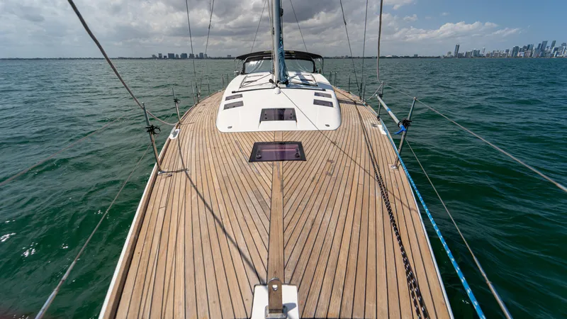 Indigo Dream Yacht Photos Pics 2012 Beneteau Sense 50 sailboat on open water, city skyline in background.