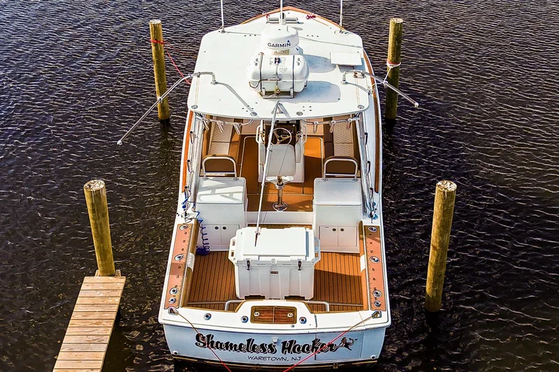  Yacht Photos Pics 2005 Egg Harbor 35' Express boat docked, aerial view, with wooden deck and fishing equipment.