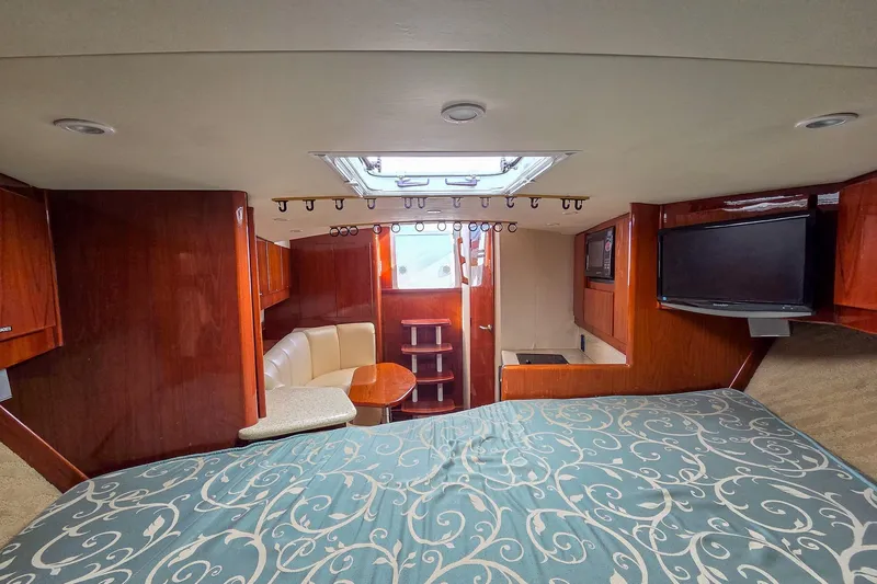  Yacht Photos Pics Interior of 2005 Egg Harbor 35' Express yacht with bed, seating, and TV.