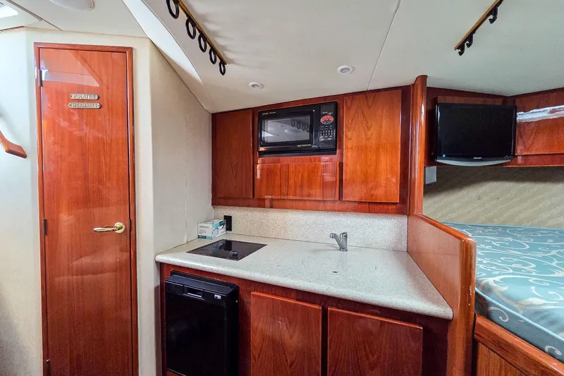  Yacht Photos Pics Interior of 2005 Egg Harbor 35' Express yacht with kitchenette and wooden cabinetry.