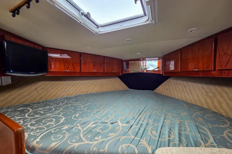 Yacht Photos Pics Interior of 2005 Egg Harbor 35' Express with bed, wood cabinets, and skylight.