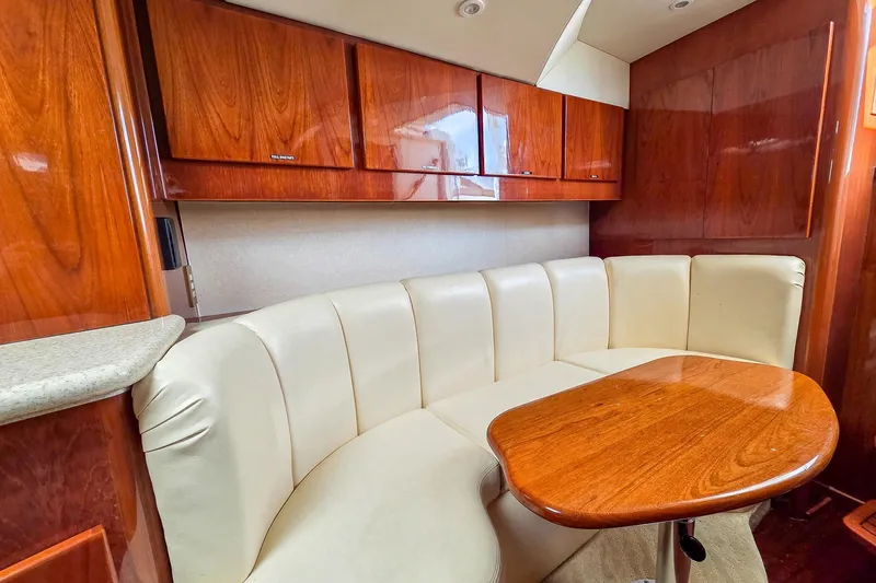  Yacht Photos Pics Luxurious interior of 2005 Egg Harbor 35' Express with leather seating and wooden cabinetry.