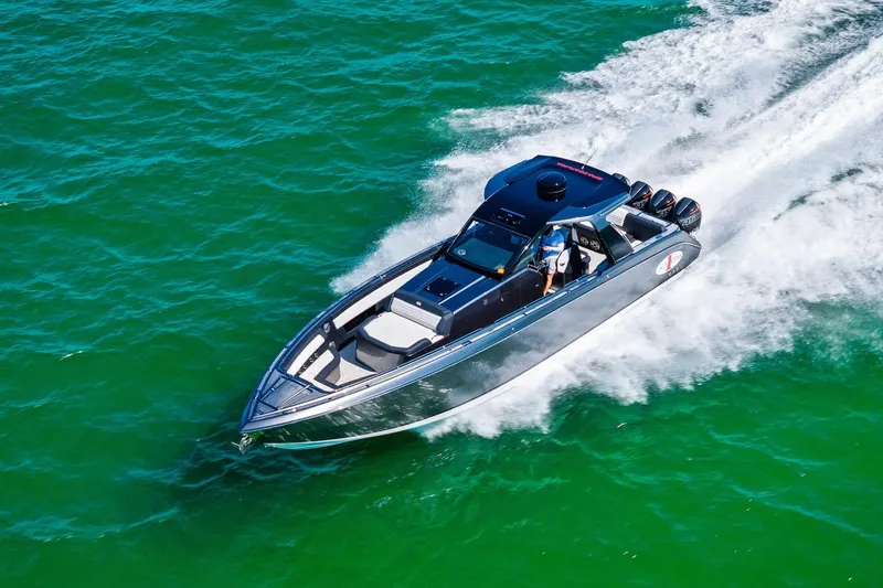  Yacht Photos Pics 2020 Cigarette 42' Auroris speedboat cruising on vibrant green water.