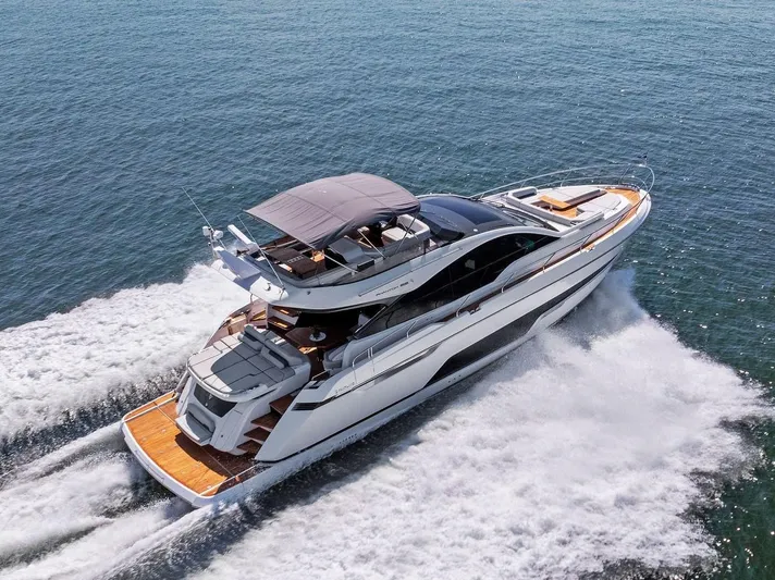  Yacht Photos Pics 2024 Fairline Phantom 65 yacht cruising on open water, showcasing sleek design and luxury features.