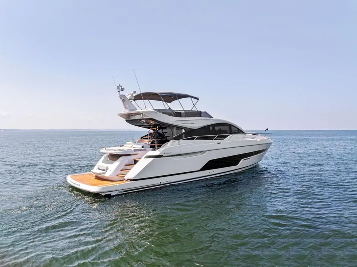 Yacht Photos Pics 2024 Fairline Phantom 65 yacht cruising on open water, showcasing sleek design and luxury features.