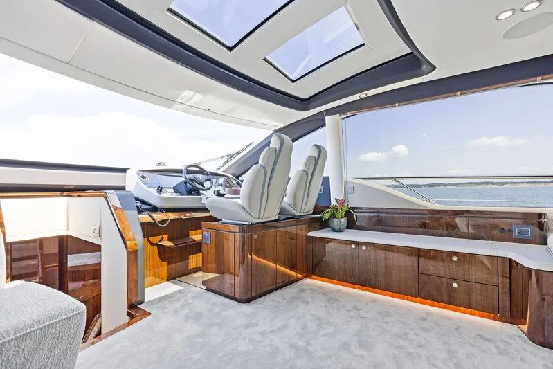  Yacht Photos Pics Luxurious interior of 2024 Fairline Phantom 65 yacht with panoramic windows and elegant seating.