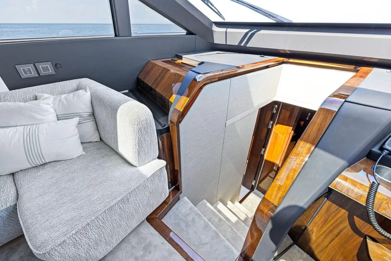  Yacht Photos Pics Luxurious interior of 2024 Fairline Phantom 65 yacht with plush seating and elegant wood finishes.