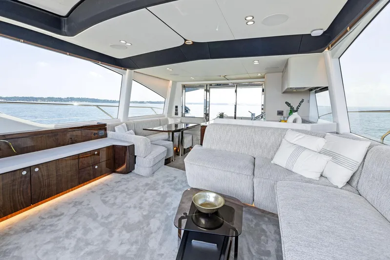  Yacht Photos Pics Luxurious interior of 2024 Fairline Phantom 65 yacht with elegant seating and panoramic windows.