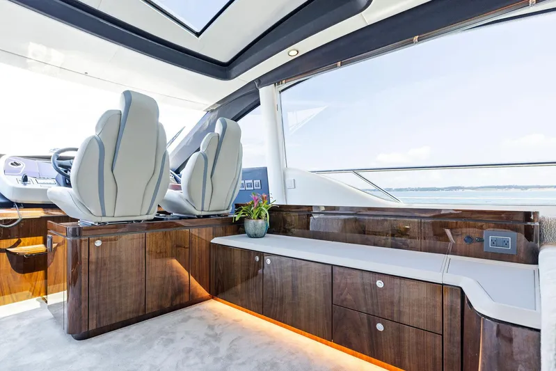  Yacht Photos Pics Luxurious interior of 2024 Fairline Phantom 65 yacht with sleek seating and wood finish.